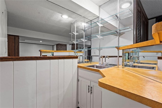 18104 E 24th St S, Independence, MO 64057 - kitchen with a sink, white cabinets, open shelves, and a textured ceiling