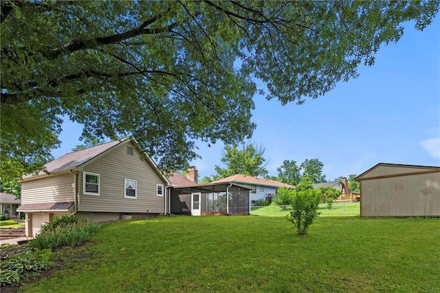 18104 E 24th St S, Independence, MO 64057 - view of grassy yard with a sunroom and an attached garage