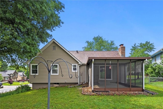 18104 E 24th St S, Independence, MO 64057 - rear view of house with a sunroom, a chimney, and roof with shingles