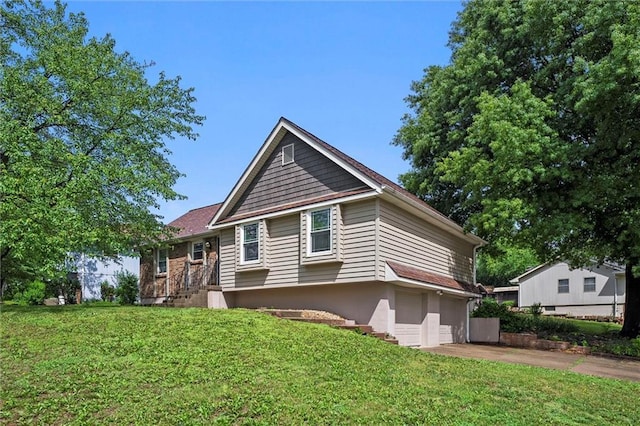 18104 E 24th St S, Independence, MO 64057 - view of front of property featuring driveway, a front lawn, and a garage