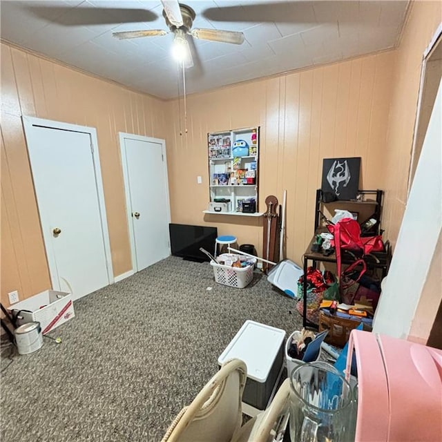 misc room featuring ceiling fan and carpet