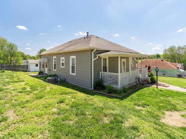 back of house with cooling unit and covered porch