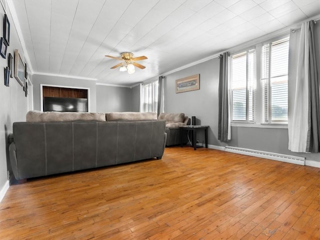 living room with a baseboard heating unit, ornamental molding, ceiling fan, light wood finished floors, and baseboards