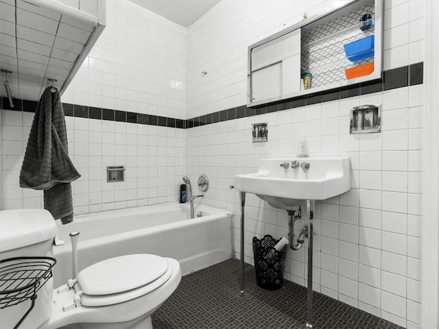 full bath with tile walls, toilet, a bath, and tile patterned flooring