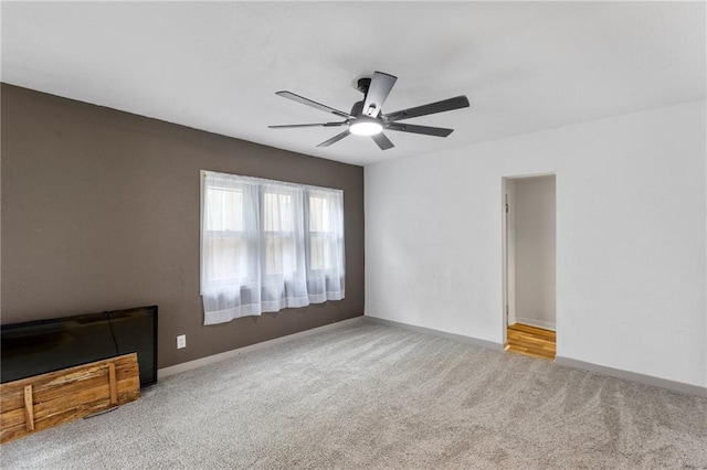 628 S Mulberry St, Ottawa, KS 66067 - unfurnished living room with carpet floors, a ceiling fan, and baseboards
