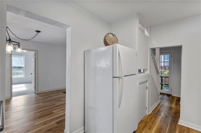 628 S Mulberry St, Ottawa, KS 66067 - kitchen featuring freestanding refrigerator, wood finished floors, plenty of natural light, and baseboards