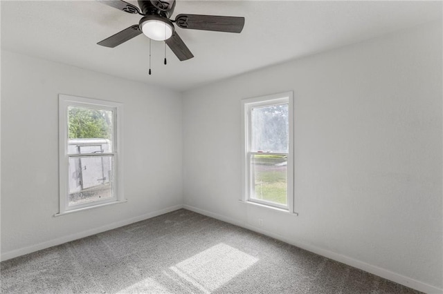 628 S Mulberry St, Ottawa, KS 66067 - carpeted spare room with baseboards and a ceiling fan