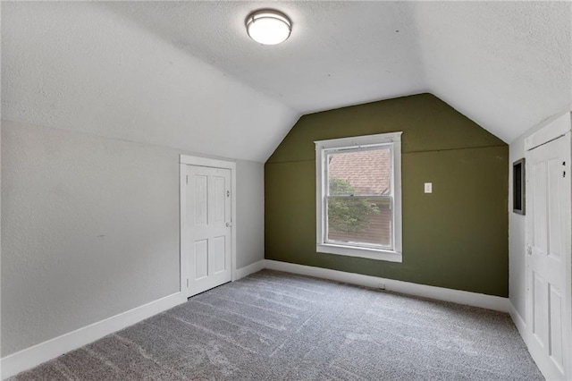 628 S Mulberry St, Ottawa, KS 66067 - additional living space with a textured ceiling, vaulted ceiling, carpet floors, and baseboards