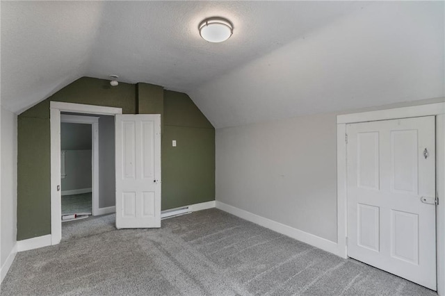 628 S Mulberry St, Ottawa, KS 66067 - additional living space featuring carpet, vaulted ceiling, a textured ceiling, and baseboards