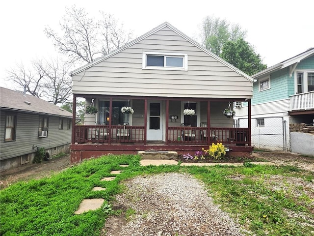 view of front of property with fence and a porch