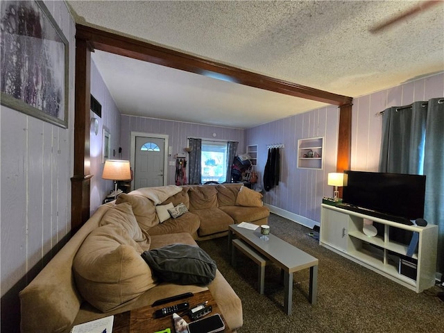carpeted living room with a textured ceiling and beam ceiling