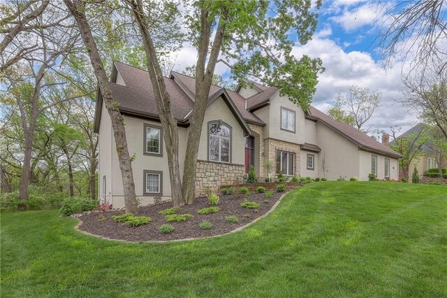4411 N Mulberry Dr, Kansas City, MO 64116 - exterior space featuring a shingled roof, stucco siding, a front yard, and stone siding