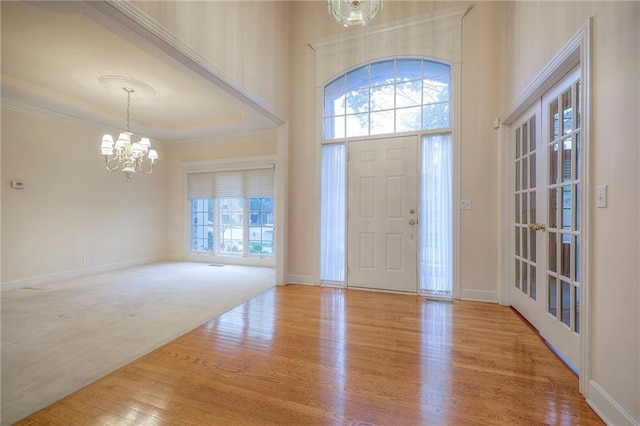 4411 N Mulberry Dr, Kansas City, MO 64116 - entryway featuring an inviting chandelier, baseboards, and wood finished floors