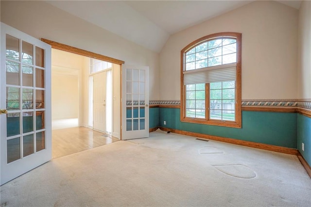 4411 N Mulberry Dr, Kansas City, MO 64116 - empty room featuring french doors, carpet, baseboards, vaulted ceiling, and visible vents