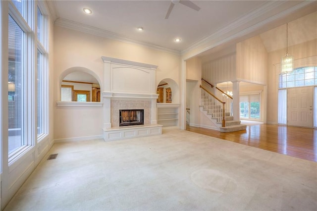 4411 N Mulberry Dr, Kansas City, MO 64116 - unfurnished living room with a ceiling fan, visible vents, ornamental molding, and light carpet