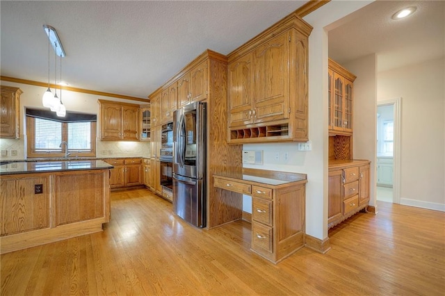 4411 N Mulberry Dr, Kansas City, MO 64116 - kitchen featuring light wood-type flooring, stainless steel refrigerator with ice dispenser, brown cabinetry, and oven