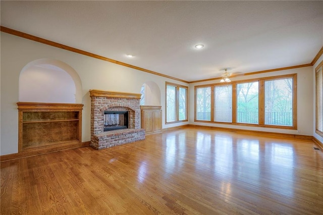 4411 N Mulberry Dr, Kansas City, MO 64116 - unfurnished living room with crown molding, baseboards, wood finished floors, and a fireplace