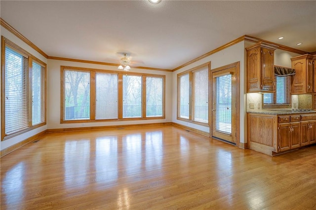 4411 N Mulberry Dr, Kansas City, MO 64116 - interior space featuring ornamental molding, baseboards, ceiling fan, plenty of natural light, and light wood-style flooring
