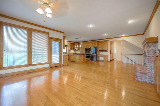 4411 N Mulberry Dr, Kansas City, MO 64116 - unfurnished living room with crown molding, baseboards, light wood-style floors, and a ceiling fan