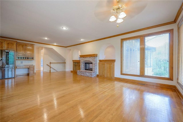 4411 N Mulberry Dr, Kansas City, MO 64116 - unfurnished living room with crown molding, a ceiling fan, baseboards, and a fireplace