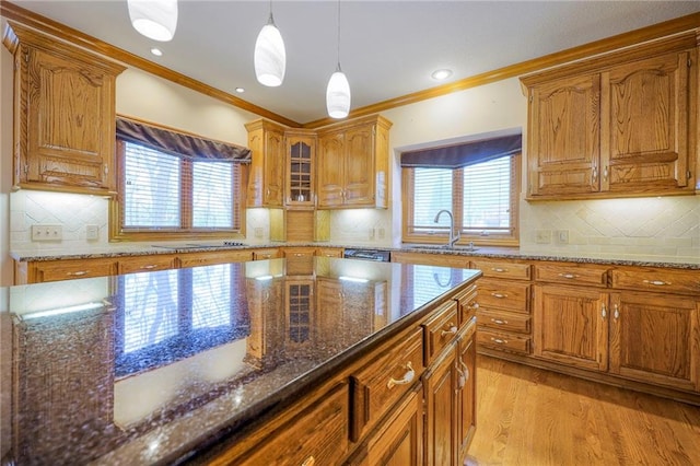 4411 N Mulberry Dr, Kansas City, MO 64116 - kitchen featuring brown cabinetry, backsplash, and decorative light fixtures