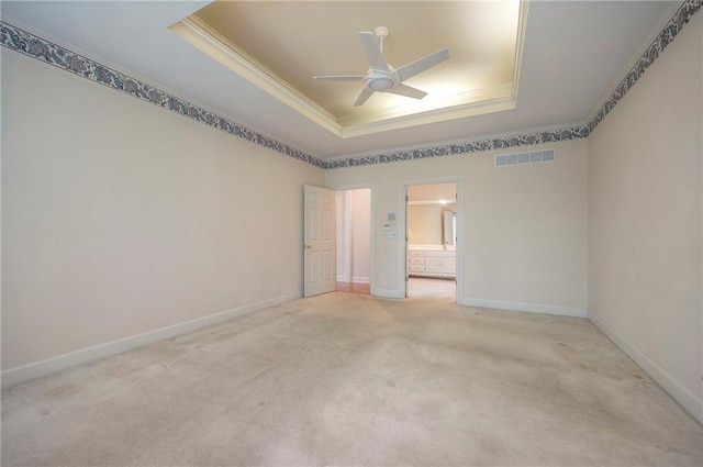 4411 N Mulberry Dr, Kansas City, MO 64116 - unfurnished room featuring visible vents, ornamental molding, ceiling fan, light colored carpet, and a tray ceiling