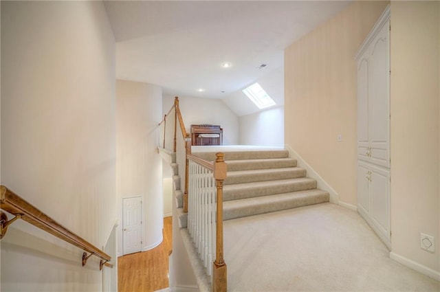 4411 N Mulberry Dr, Kansas City, MO 64116 - staircase featuring recessed lighting, baseboards, and vaulted ceiling with skylight