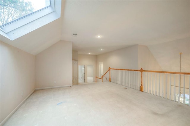 4411 N Mulberry Dr, Kansas City, MO 64116 - additional living space with plenty of natural light, carpet flooring, lofted ceiling with skylight, and recessed lighting