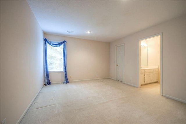 4411 N Mulberry Dr, Kansas City, MO 64116 - unfurnished bedroom with baseboards, ensuite bathroom, visible vents, and light carpet