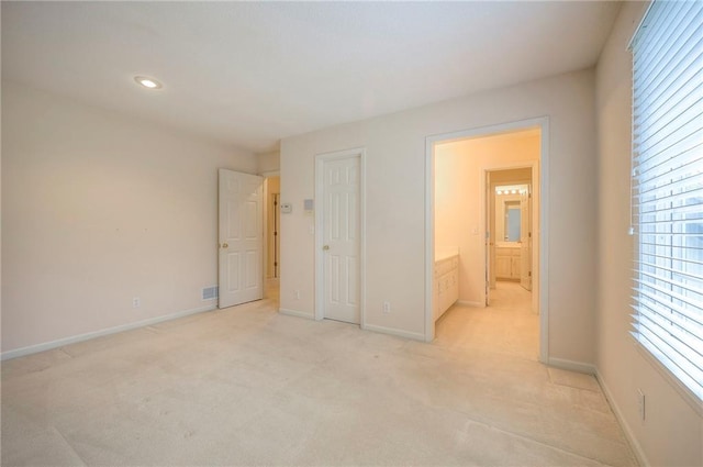 4411 N Mulberry Dr, Kansas City, MO 64116 - unfurnished bedroom featuring light carpet, recessed lighting, baseboards, ensuite bathroom, and visible vents