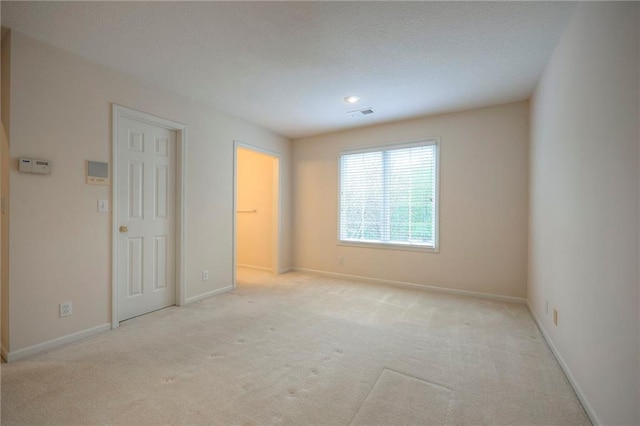 4411 N Mulberry Dr, Kansas City, MO 64116 - empty room featuring light colored carpet, baseboards, and visible vents