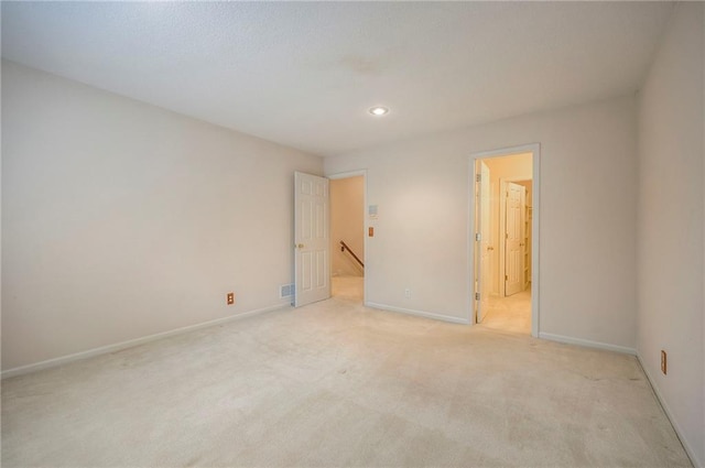 4411 N Mulberry Dr, Kansas City, MO 64116 - unfurnished bedroom with visible vents, light carpet, baseboards, recessed lighting, and ensuite bath