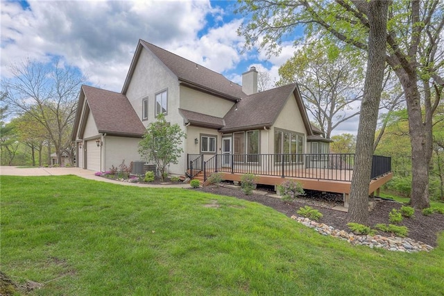4411 N Mulberry Dr, Kansas City, MO 64116 - view of property exterior with a deck, stucco siding, a chimney, an attached garage, and a yard
