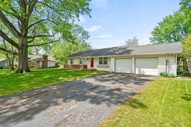 ranch-style home featuring aphalt driveway, a front lawn, and a garage