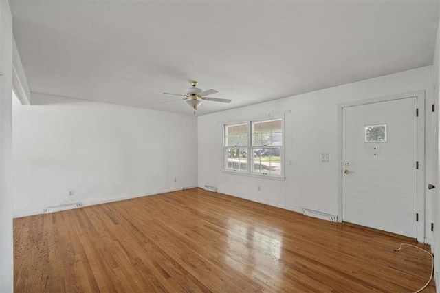 unfurnished living room featuring light wood-style floors, a ceiling fan, baseboards, and visible vents