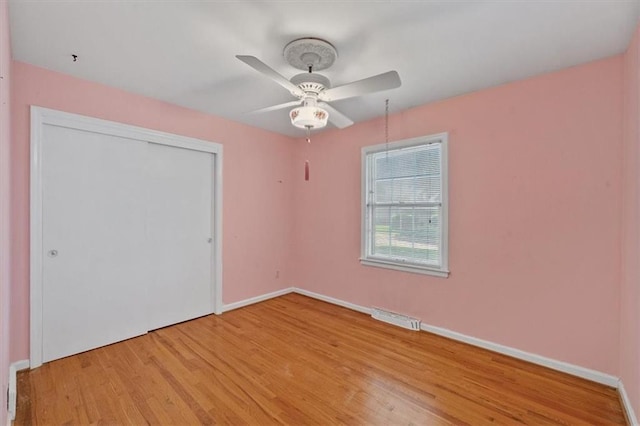 unfurnished bedroom with baseboards, light wood-style flooring, and visible vents