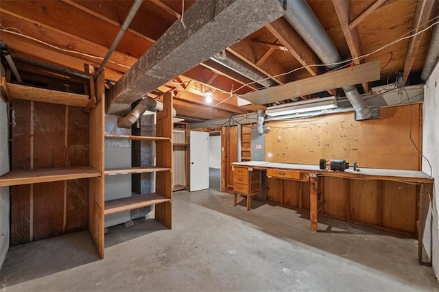 unfinished below grade area featuring a workshop area
