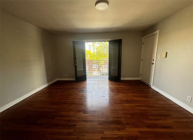 empty room with wood finished floors and baseboards