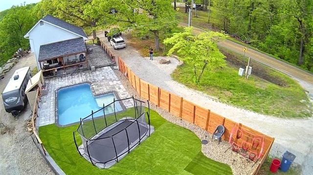 pool featuring a lawn and a fenced backyard