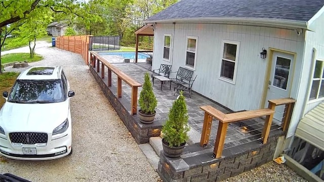 exterior space with a fenced in pool and a patio area