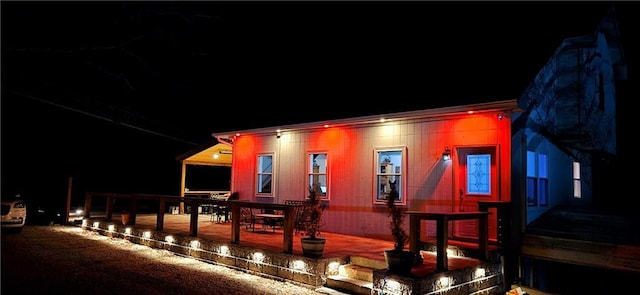 back of house at twilight with a patio area