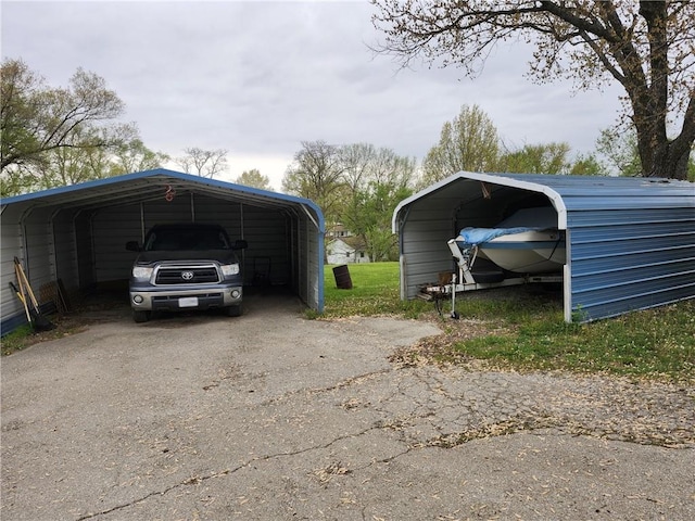 view of vehicle parking featuring aphalt driveway and a carport