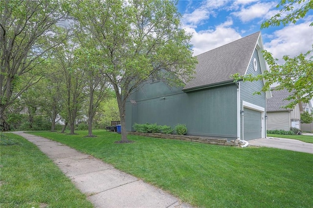 view of side of home featuring a lawn, a garage, roof with shingles, and driveway