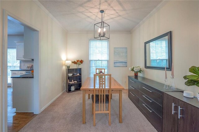 dining room featuring crown molding, a notable chandelier, plenty of natural light, and light carpet