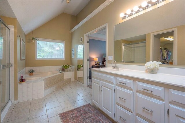 bathroom with a garden tub, a stall shower, vanity, tile patterned floors, and lofted ceiling