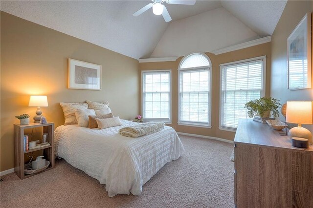 bedroom with baseboards, light colored carpet, ceiling fan, and lofted ceiling