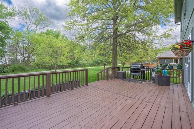 wooden deck featuring a yard and area for grilling
