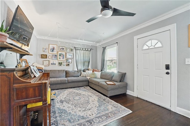 living room with a ceiling fan, baseboards, ornamental molding, and wood finished floors