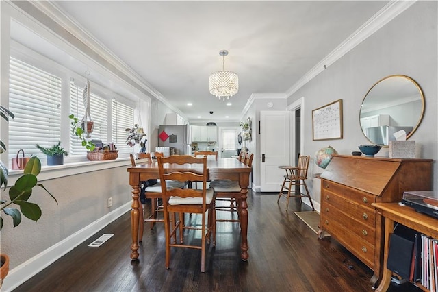 dining area featuring crown molding, an inviting chandelier, wood finished floors, and a healthy amount of sunlight