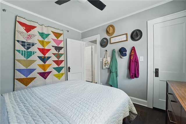 bedroom with dark wood-type flooring, baseboards, crown molding, and ceiling fan